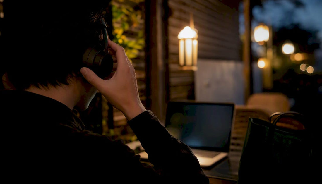 Hands adjusting wireless headphones outdoors